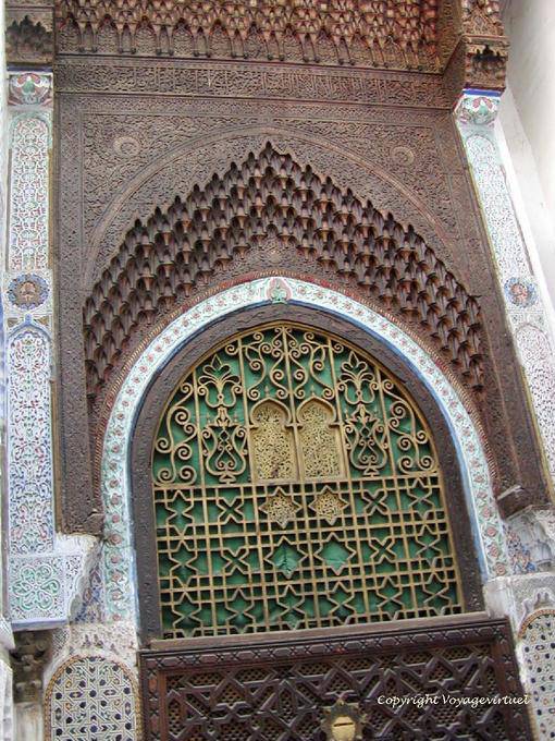 Top of carved wooden door with arch muqarnas, Fes - Morocco