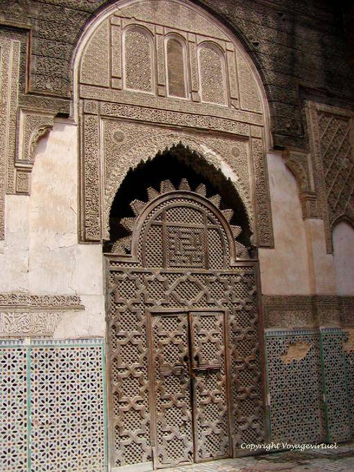 A carved wooden door and stucco Sahrij Medersa, Fes - Morocco