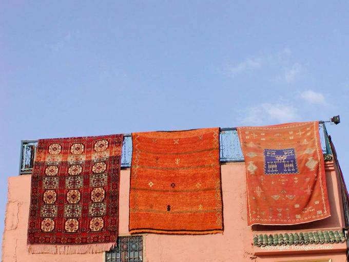 Carpet presentations on sky background, Jemaa el Fna, Marrakech - Morocco