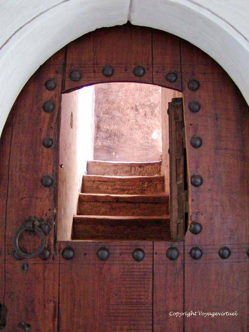 Opening in a wooden door and staircase, Ben Youssef Madrasa, Marrakech - Morocco