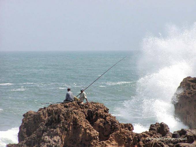 Foam and anglers on the rocks of the pass, Oualidia - Morocco