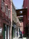 Street in the Medina with covered windows with wrought iron, Marrakech, Morocco.