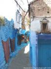 Carpets hanging on the colored wall, Chefchaouen, Morocco.