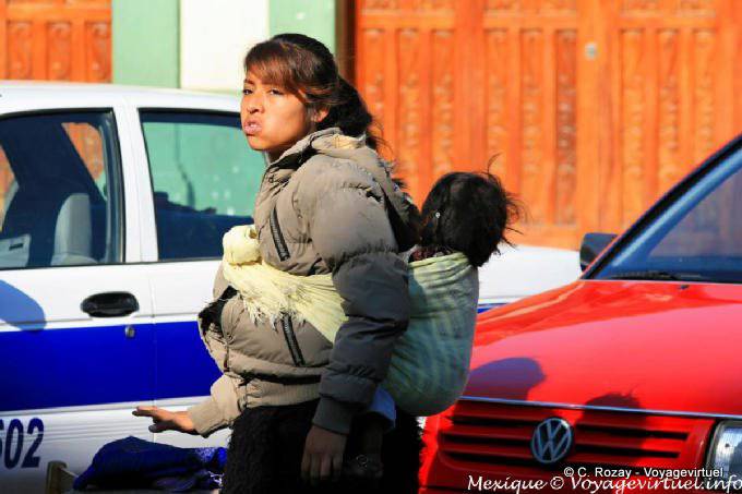Young woman carrying a child on his back, Chiapas - Mexico