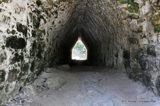 Mayan arch tunnel leading down to a chamber in the pyramid Coba - Mexico