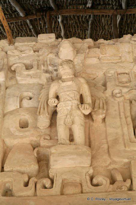 Stucco warrior wearing a feather plume masks background, Jaguar Altar, Ek Balam - Mexico