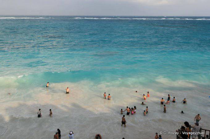 Swimming on the beach of the Maya site Tulum - Mexico
