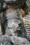 Focus on the face of the statue, east side, Jaguar sculpture, Kabah, Mexico.