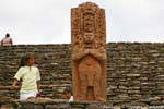 Curious children before the statue of the sixth century representing the sovereign B'alam Ya Acal, Tonina, Mexico.