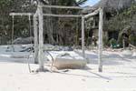 Bed suspended on a beach to Tulum, Mexico.