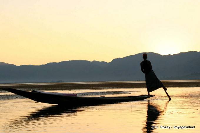 The Intha fisherman sculling with an oar around which winds its leg, Inle Lake - Myanmar (Burma)