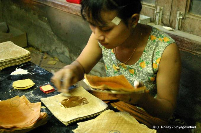 Working fashioning gold leaf, Mandalay - Myanmar (Burma)