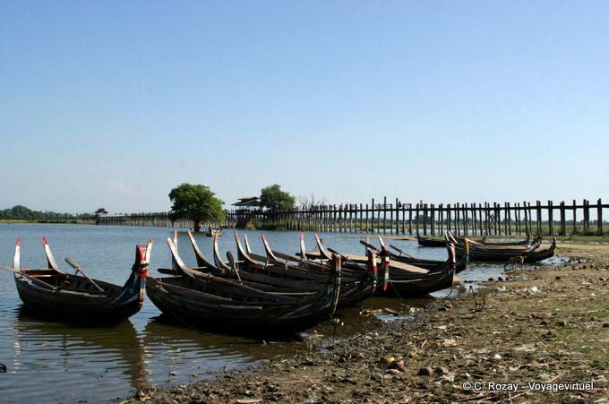 U Bein Bridge and traditional boats moored, Lake Taungthaman, Mandalay - Myanmar (Burma)