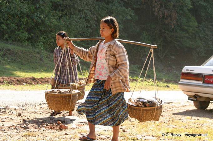 Young Burmese carrying a balance, Kyaukpadaung Road, Mount Popa - Myanmar (Burma)