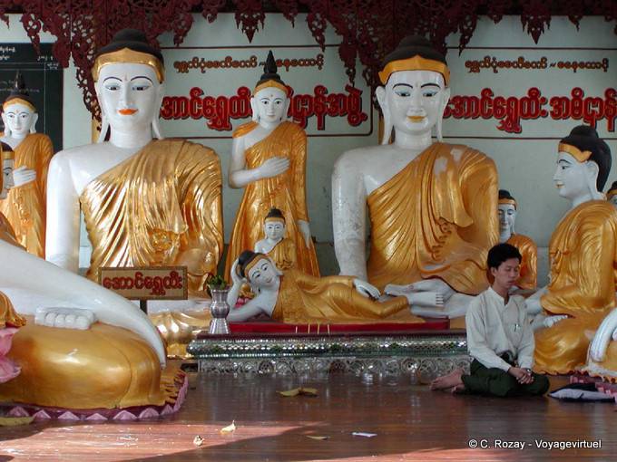 Meditation kneeling at the foot of the Buddhas, Shwedagon Pagoda, Yangon - Myanmar (Burma)