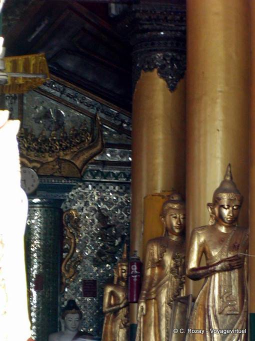 Columns and standing Buddhas in a temple of Shwedagon Pagoda, Yangon - Myanmar (Burma)