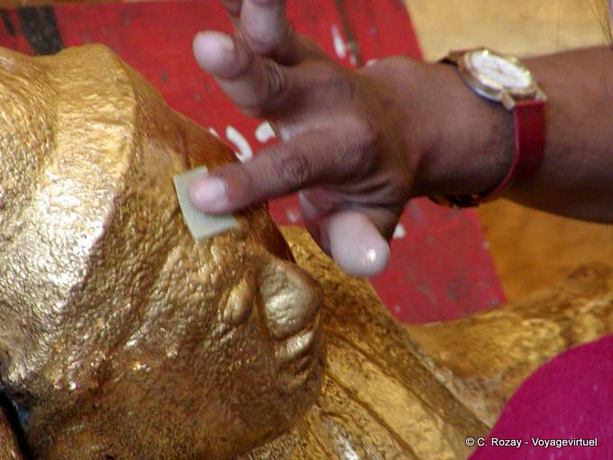 Gold leaf laid on the head of a Buddha, Rangoon - Myanmar (Burma)