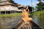 Young Burmese traditional canoe paddling, Inle Lake, Burma.