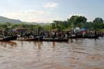 The start of the market, the crowds on the shore of Lake Inle, Burma.