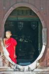 Young monk at the monastery gate Shwe Yan Pyay, Inle Lake, Burma.