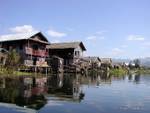 Passing in front of lake houses, Inle Lake, Burma.