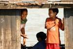 Smiles in passing boat on the Irrawaddy, Mandalay, Burma.