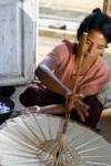 Woman checking the quality of the umbrella, Pindaya, Burma.