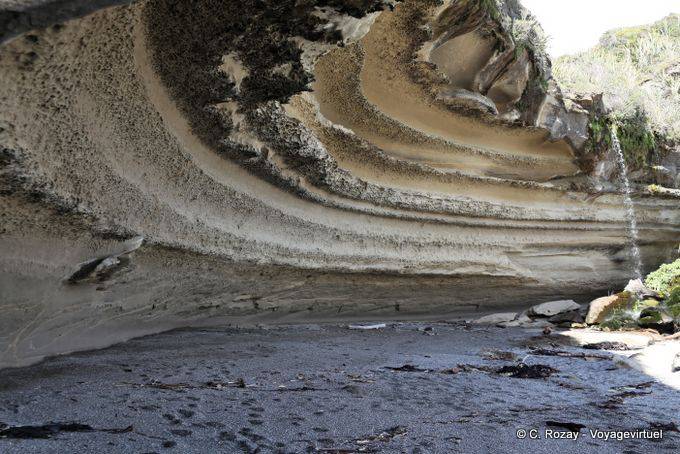Waterfall and cliff cave on the beach, Paparoa Park, Truman Track, Westcoast - New Zealand