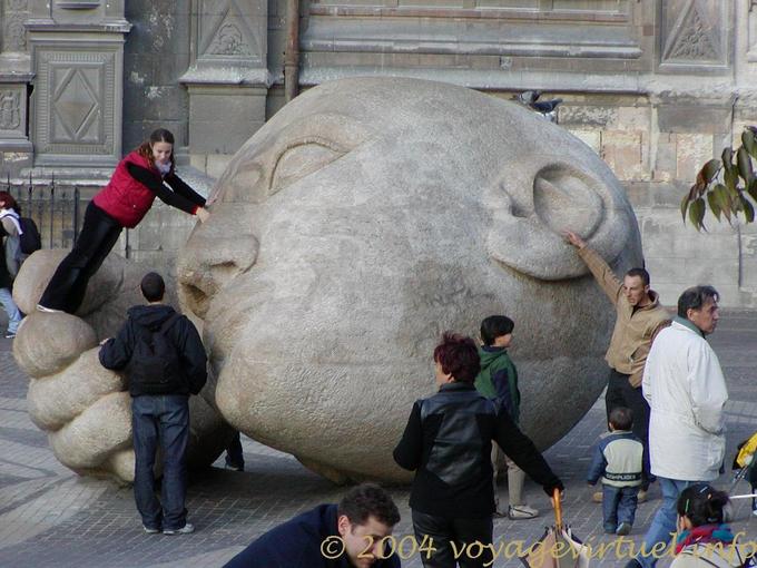 Games on the head of the sculpture The Listening, Paris, France