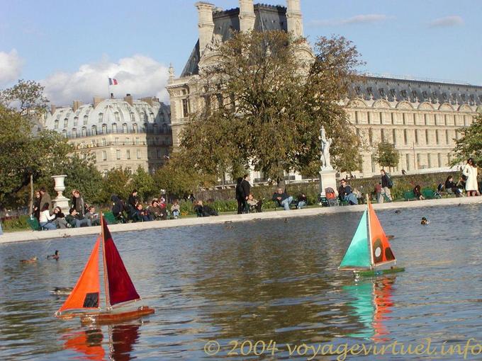 Small boats are going on the water, sailboats in Jardin des Tuileries, Paris, France