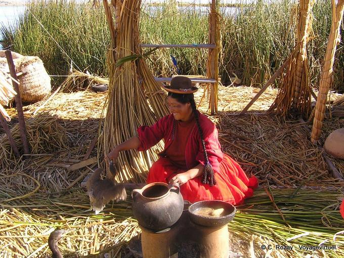 Sharing with the farmyard in traditional costume, Titicaca -Peru