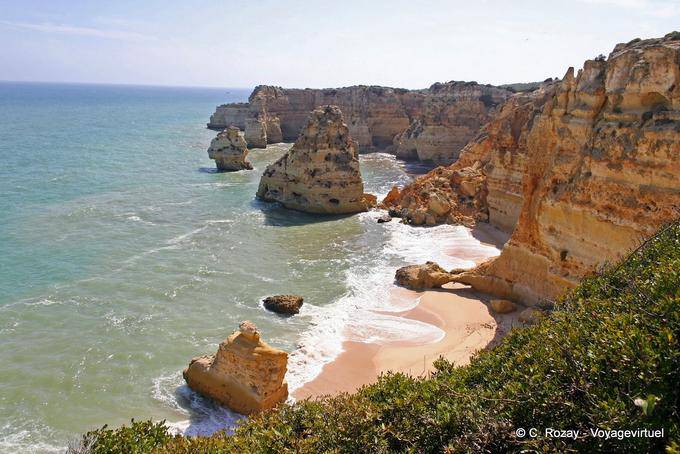 Cliff and pink sand of the coast of the Algarve - Portugal