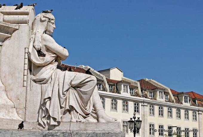 Pigeon on statue at the foot of the column of Dom Pedro IV, Rossio, Lisbon - Portugal