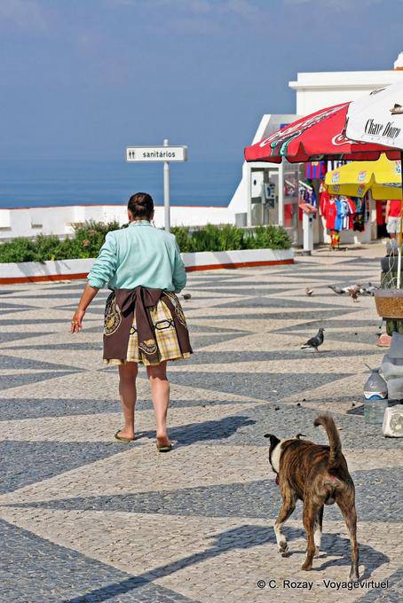 The woman and her dog, Largo de Nossa Senhora da Nazaré - Portugal