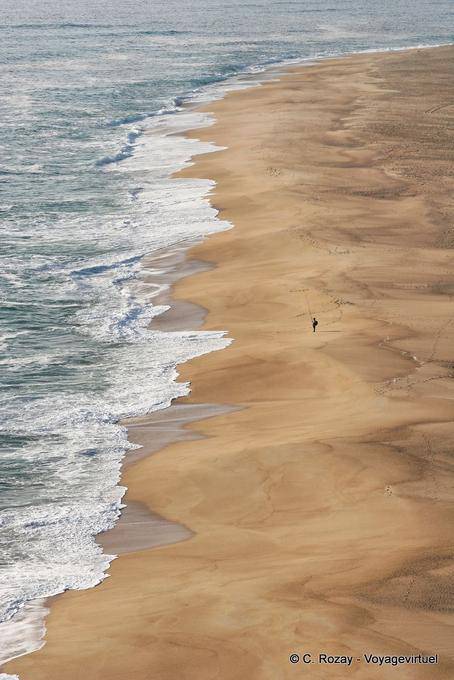 The fisherman alone on the vast beach north of Nazaré - Portugal