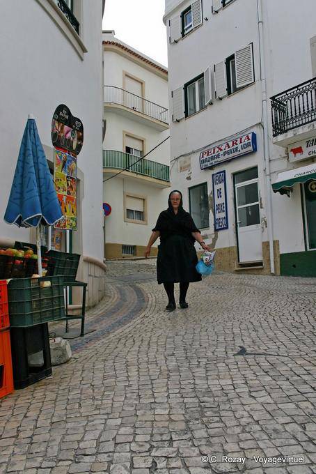 The woman in black in the cobbled street, Nazaré - Portugal