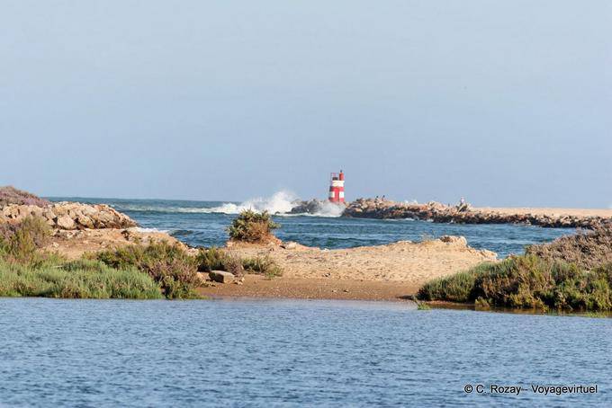 Lighthouse at the mouth of estuary Formosa, Tavira - Portugal