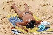 Women sunbathing on the beach, Albufeira, Portugal.