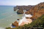 Cliff and pink sand of the coast of the Algarve, Portugal.