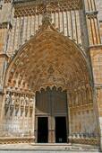 The main portal with tympanum and arches, west of the Monastery of Batalha, Portugal.