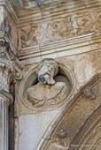 Coimbra, head carved out of a medallion, rua São Salvador, Portugal.