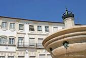 Fountain and facade of the Praça de Giraldo, Évora, Portugal.