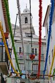 Festive preparations and tower of São Estêvão, Alfama, Lisbon, Portugal.