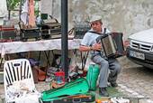 Graça, an accordionist market Santa Clara, Lisbon, Portugal.