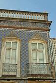 Style house covered with ceramic tiles, Tavira, Portugal.