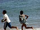 Kids racing on the beach, Saint-Leu, Reunion.