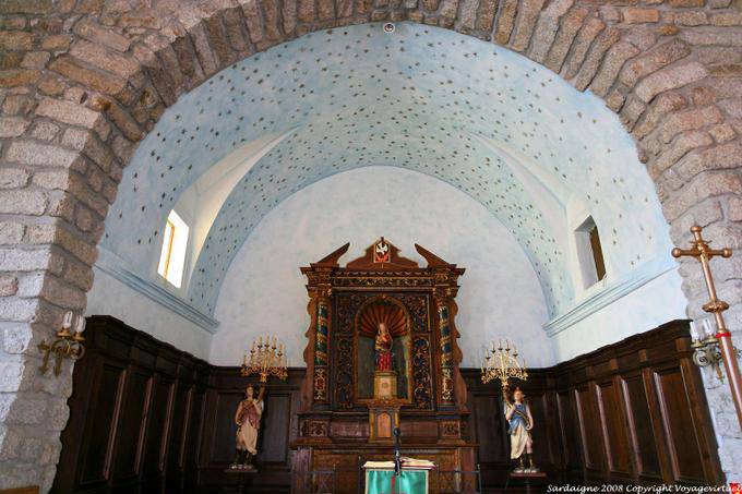 Altar statue of Our Lady of the Snows lit by two wooden angels, Santa Maria della Neve Chiesa, Arzachena - Sardinia