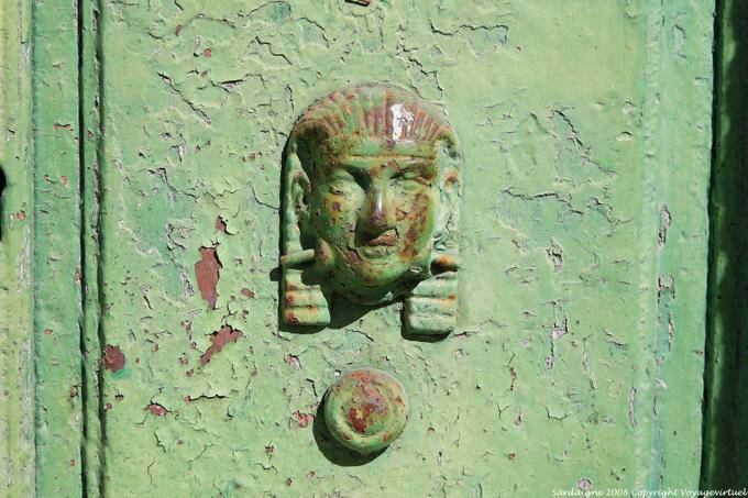 Luogosanto via Carducci, sphinx on an iron door - Sardinia