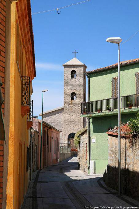 Trinità d'Agultu e Vignola, the bell tower of the parish and typical street - Sardinia