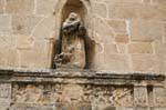Alghero, Chiesa San Francesco, outdoor statue in a niche and low relief, Sardinia.
